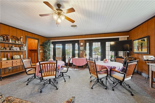 2108 Washington St, Franklinton, LA 70438 - dining room featuring wood walls, french doors, and a ceiling fan