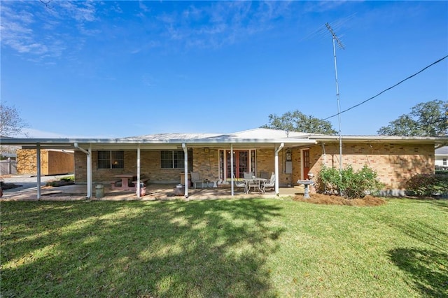 2108 Washington St, Franklinton, LA 70438 - rear view of property with a yard, a patio area, and brick siding