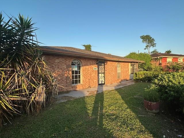 9416 Cabildo Ln, Westwego, LA 70094 - rear view of house with a lawn and brick siding