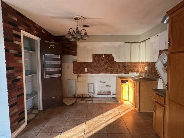 9416 Cabildo Ln, Westwego, LA 70094 - kitchen featuring a chandelier, tile patterned flooring, decorative backsplash, and hanging light fixtures