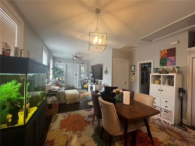 2716 Lavender St, New Orleans, LA 70122 - dining room with attic access, a chandelier, wood finished floors, and a ceiling fan
