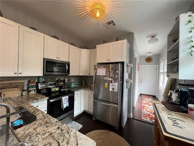 2716 Lavender St, New Orleans, LA 70122 - kitchen with appliances with stainless steel finishes, light stone countertops, dark wood finished floors, and white cabinetry