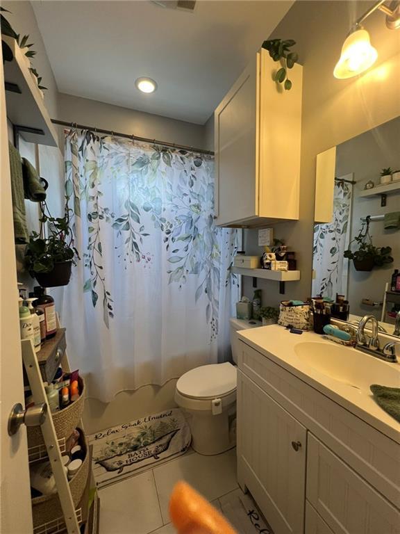 2716 Lavender St, New Orleans, LA 70122 - bathroom featuring toilet, vanity, and tile patterned floors