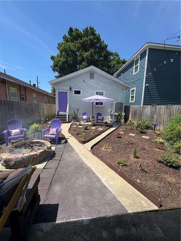 2716 Lavender St, New Orleans, LA 70122 - rear view of property featuring a fire pit, a patio area, and entry steps