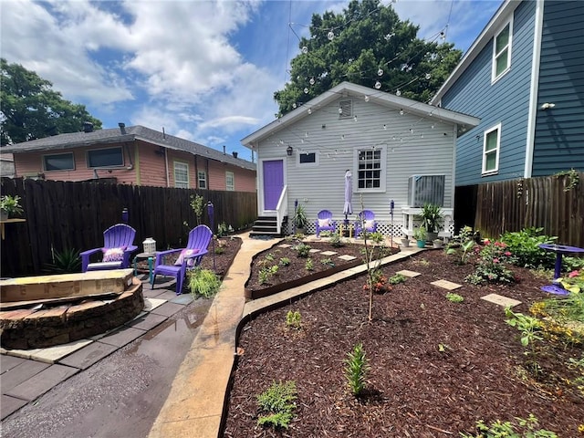 2716 Lavender St, New Orleans, LA 70122 - rear view of house with an outdoor fire pit, entry steps, and a patio area