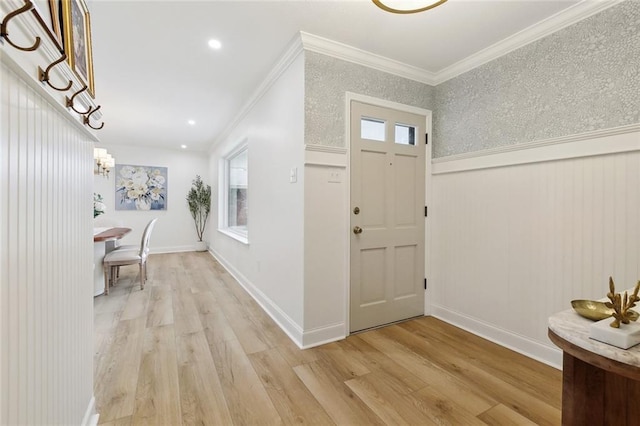 4905 Haring Ct, Metairie, LA 70006 - foyer entrance with light wood-style floors, a wainscoted wall, crown molding, and a chandelier