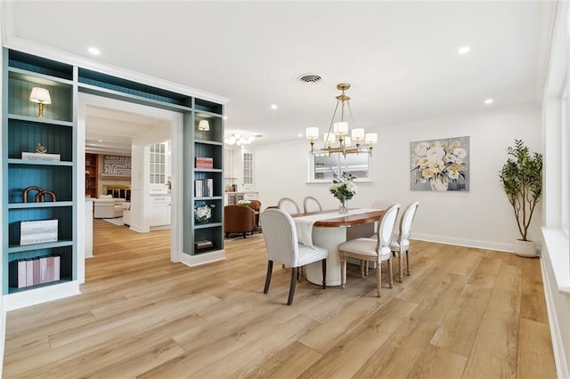 4905 Haring Ct, Metairie, LA 70006 - dining room with a chandelier, light wood-type flooring, ornamental molding, recessed lighting, and baseboards