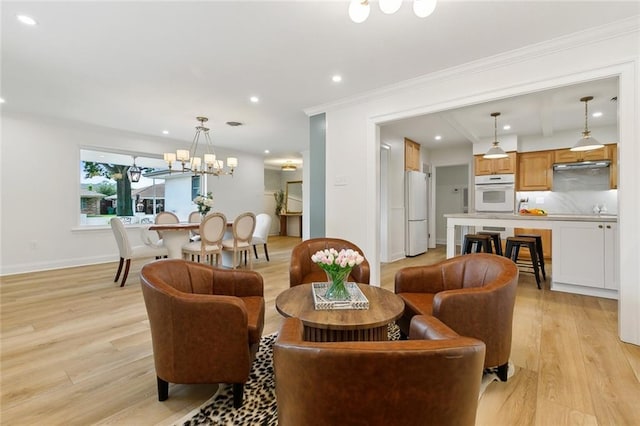 4905 Haring Ct, Metairie, LA 70006 - living area featuring light wood-style flooring, baseboards, a chandelier, recessed lighting, and crown molding