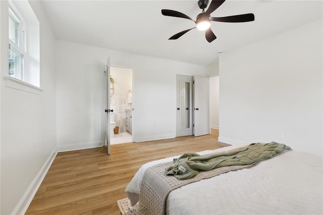 4905 Haring Ct, Metairie, LA 70006 - bedroom featuring light wood-type flooring, baseboards, ceiling fan, and connected bathroom