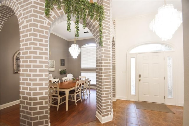 62283 Chappepeela Ridge Rd, Amite, LA 70422 - foyer entrance with a chandelier, arched walkways, ornamental molding, baseboards, and tile patterned floors