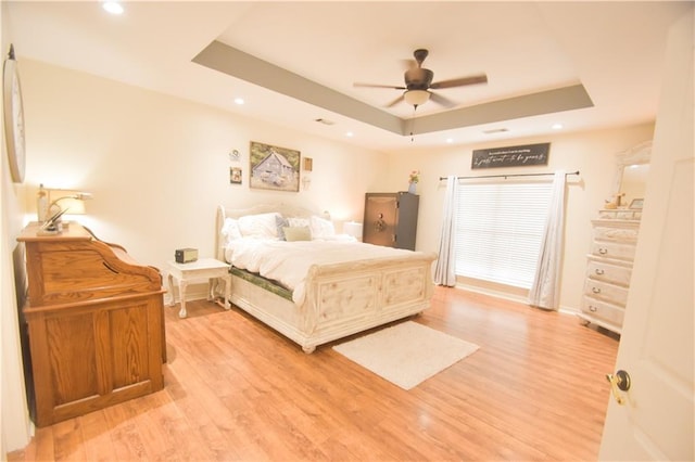 62283 Chappepeela Ridge Rd, Amite, LA 70422 - bedroom featuring a tray ceiling, light wood-style floors, baseboards, recessed lighting, and a ceiling fan