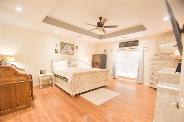 62283 Chappepeela Ridge Rd, Amite, LA 70422 - bedroom featuring a tray ceiling, baseboards, light wood-type flooring, recessed lighting, and a ceiling fan