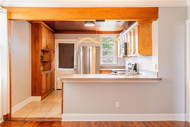 1017 Marian Ave, Metairie, LA 70001 - kitchen with appliances with stainless steel finishes, light countertops, a peninsula, light wood-type flooring, and wood ceiling