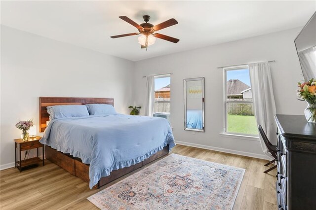 2641 Anchor Dr, Marrero, LA 70072 - bedroom with multiple windows, light wood-style floors, baseboards, and ceiling fan