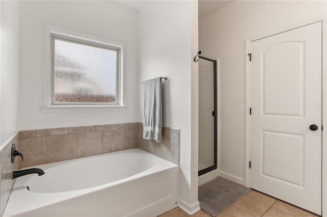2641 Anchor Dr, Marrero, LA 70072 - bathroom featuring a bath, a stall shower, tile patterned floors, and baseboards