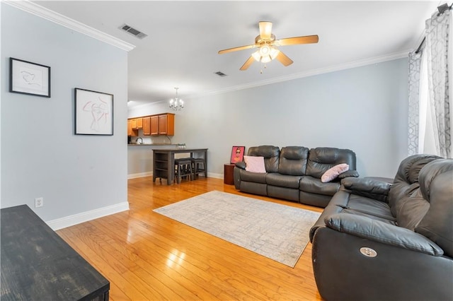 5315 Arlington Ct, Baton Rouge, LA 70820 - living room with a ceiling fan, light wood finished floors, a chandelier, and crown molding