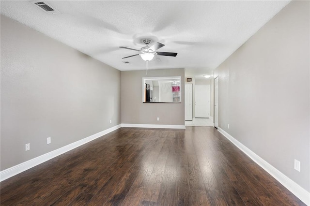 139 Avant Garde Cir Unit 139, Kenner, LA 70065 - empty room with ceiling fan, dark wood finished floors, baseboards, and a textured ceiling