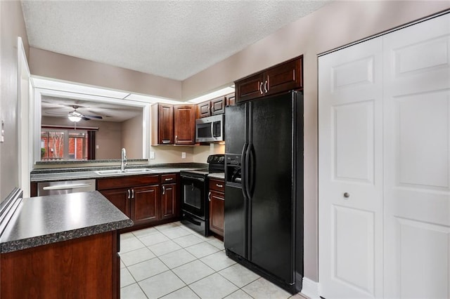 139 Avant Garde Cir Unit 139, Kenner, LA 70065 - kitchen with black appliances, a sink, dark countertops, light tile patterned floors, and a textured ceiling