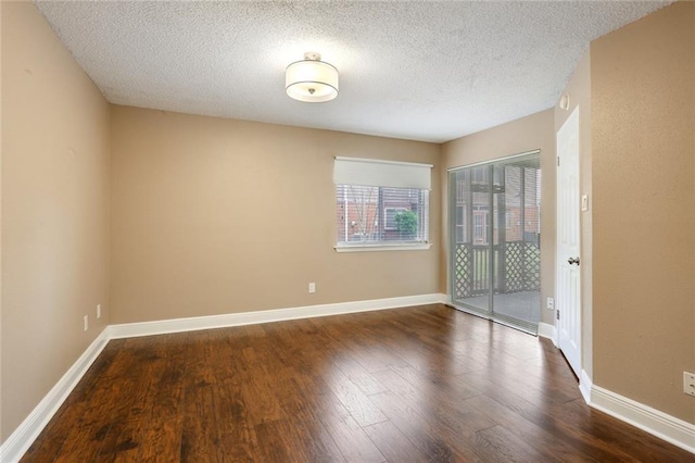139 Avant Garde Cir Unit 139, Kenner, LA 70065 - unfurnished room with dark wood-style floors, a textured ceiling, and baseboards