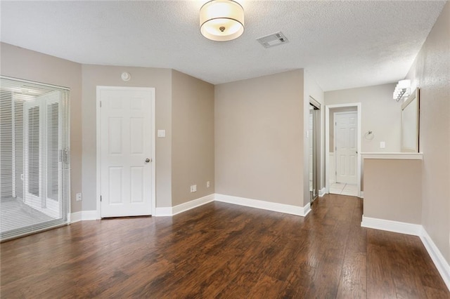 139 Avant Garde Cir Unit 139, Kenner, LA 70065 - unfurnished room with wood finished floors, baseboards, and a textured ceiling