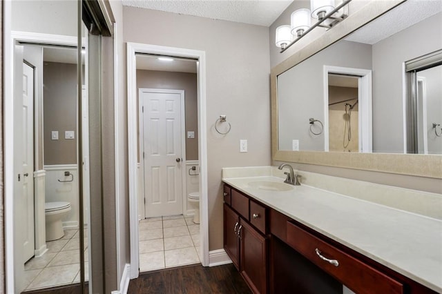 139 Avant Garde Cir Unit 139, Kenner, LA 70065 - full bath featuring toilet, vanity, a textured ceiling, tile patterned flooring, and baseboards