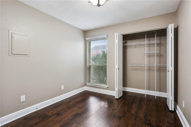 139 Avant Garde Cir Unit 139, Kenner, LA 70065 - unfurnished bedroom with wood-type flooring, a closet, baseboards, and a textured ceiling