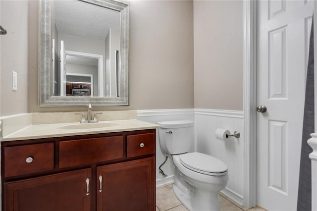 139 Avant Garde Cir Unit 139, Kenner, LA 70065 - bathroom with toilet, wainscoting, vanity, a textured ceiling, and tile patterned flooring
