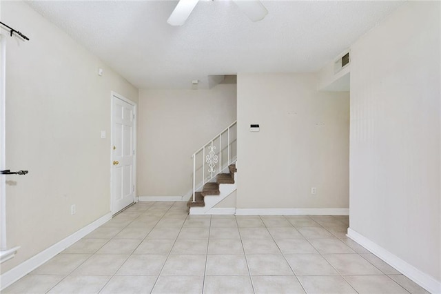1729 Newport Pl Unit 9, Kenner, LA 70065 - entryway featuring ceiling fan, stairway, a textured ceiling, and light tile patterned flooring