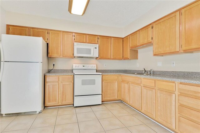 1729 Newport Pl Unit 9, Kenner, LA 70065 - kitchen with white appliances, a sink, light brown cabinets, light tile patterned flooring, and light countertops