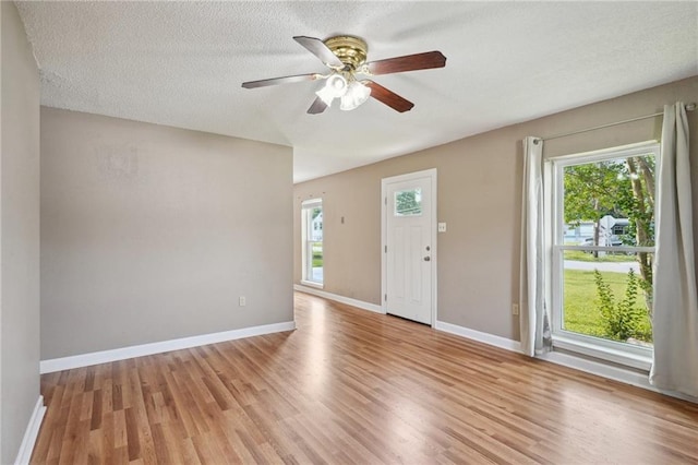 4124 Ames Blvd, Marrero, LA 70072 - entrance foyer with healthy amount of natural light, light wood-type flooring, ceiling fan, baseboards, and a textured ceiling