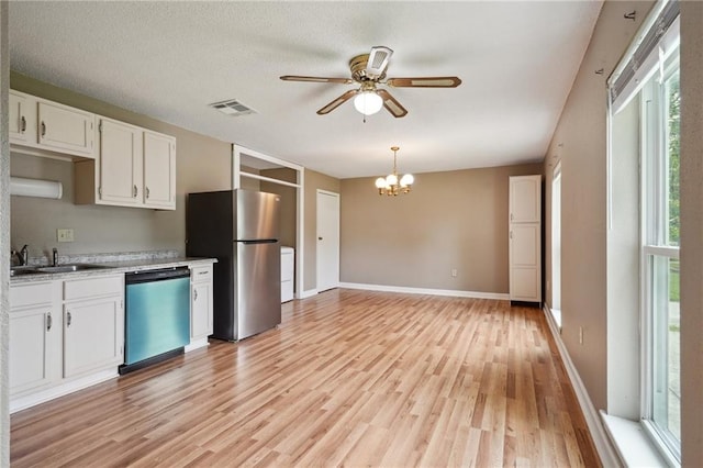 4124 Ames Blvd, Marrero, LA 70072 - kitchen with dishwashing machine, freestanding refrigerator, a sink, ceiling fan, and a chandelier