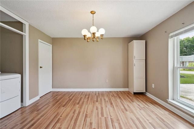 4124 Ames Blvd, Marrero, LA 70072 - unfurnished dining area with a chandelier, light wood-style flooring, washer / clothes dryer, and baseboards