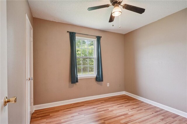 4124 Ames Blvd, Marrero, LA 70072 - spare room with wood finished floors, baseboards, a ceiling fan, and a textured ceiling