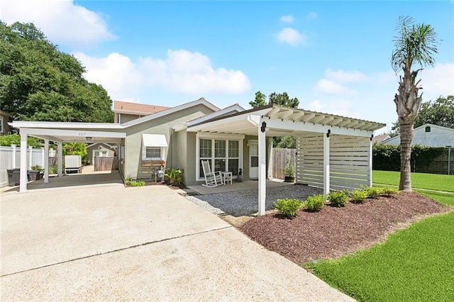 623 Bonnabel Blvd, Metairie, LA 70005 - view of front of property with driveway, an attached carport, and stucco siding
