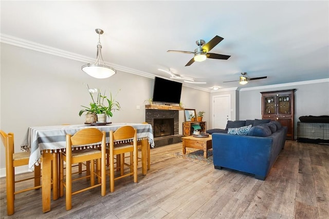 623 Bonnabel Blvd, Metairie, LA 70005 - dining area featuring ceiling fan, wood finished floors, crown molding, and a fireplace with raised hearth