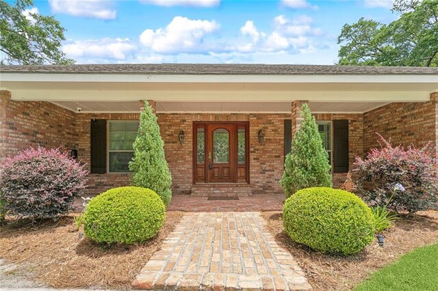 63 Doubloon Dr, Slidell, LA 70461 - doorway to property with brick siding and covered porch