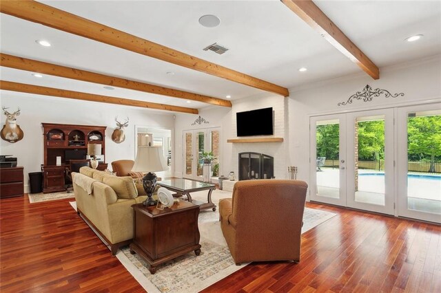 63 Doubloon Dr, Slidell, LA 70461 - living area with beamed ceiling, wood finished floors, french doors, recessed lighting, and a fireplace