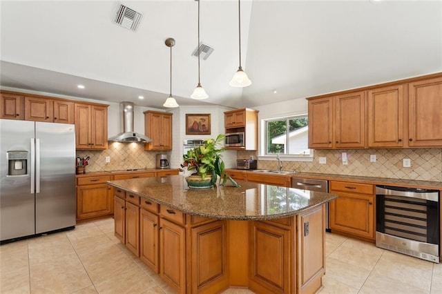 63 Doubloon Dr, Slidell, LA 70461 - kitchen featuring stainless steel appliances, wine cooler, wall chimney exhaust hood, light tile patterned floors, and a center island