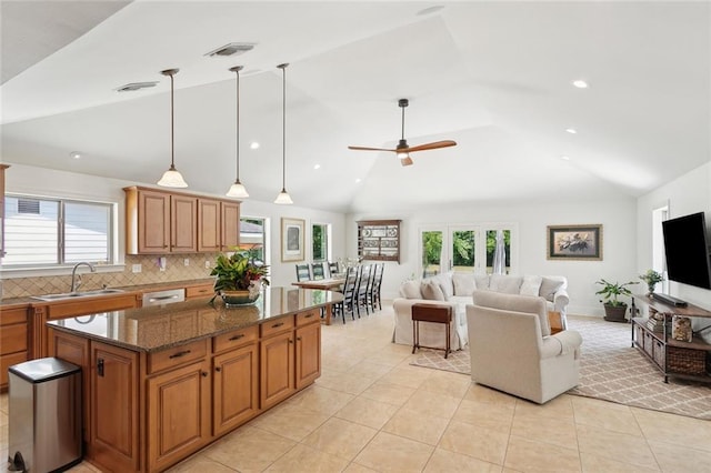 63 Doubloon Dr, Slidell, LA 70461 - kitchen featuring a sink, lofted ceiling, a kitchen island, brown cabinets, and open floor plan