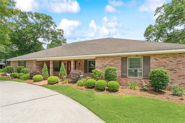 63 Doubloon Dr, Slidell, LA 70461 - ranch-style house with brick siding, a front yard, and roof with shingles