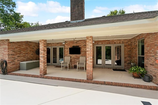 63 Doubloon Dr, Slidell, LA 70461 - rear view of property featuring french doors, brick siding, a chimney, and a patio area
