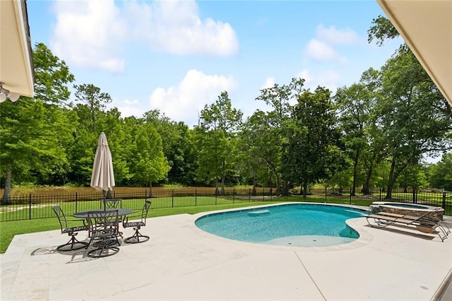 63 Doubloon Dr, Slidell, LA 70461 - view of pool with a patio area, a pool with connected hot tub, and view of wooded area