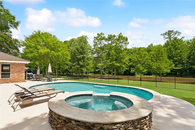 63 Doubloon Dr, Slidell, LA 70461 - view of pool featuring a patio, a pool with connected hot tub, and view of scattered trees