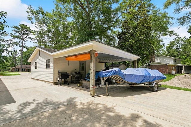 63 Doubloon Dr, Slidell, LA 70461 - view of patio featuring concrete driveway, a grill, and an attached carport
