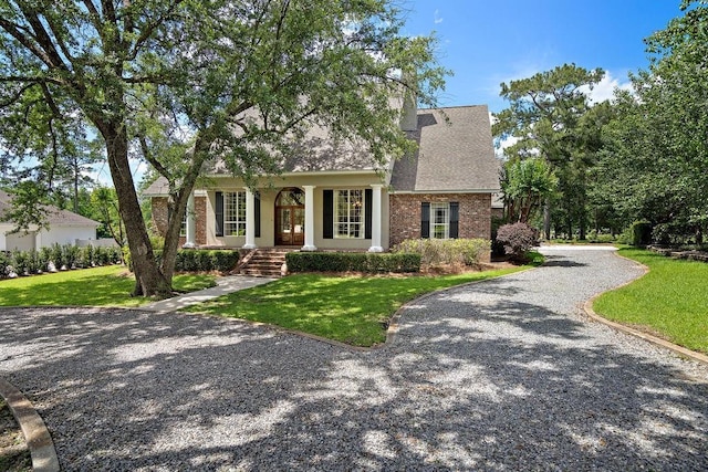 444 Trailhead Dr, Abita Springs, LA 70420 - view of front of house featuring a front lawn, brick siding, and french doors