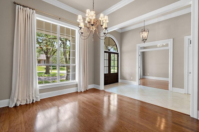 444 Trailhead Dr, Abita Springs, LA 70420 - unfurnished dining area with a chandelier, crown molding, baseboards, french doors, and wood finished floors