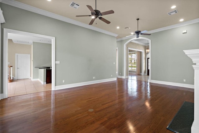 444 Trailhead Dr, Abita Springs, LA 70420 - unfurnished living room with ceiling fan, arched walkways, wood finished floors, recessed lighting, and ornamental molding
