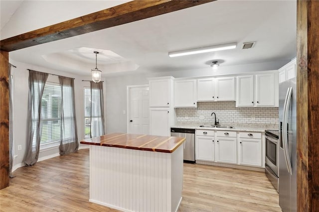 185 Lark St, Slidell, LA 70460 - kitchen with a sink, appliances with stainless steel finishes, butcher block countertops, light wood-type flooring, and white cabinetry