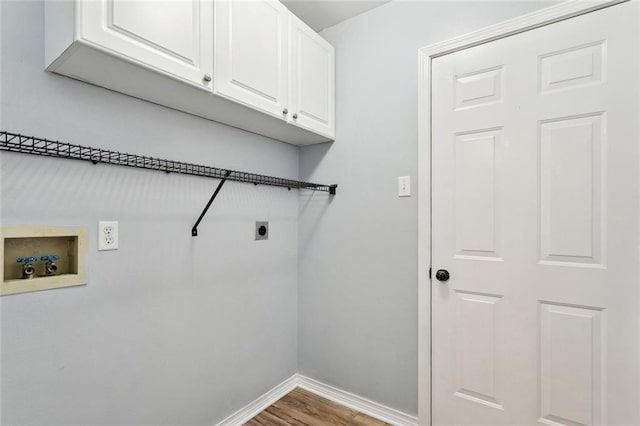 185 Lark St, Slidell, LA 70460 - laundry area featuring electric dryer hookup, washer hookup, baseboards, wood finished floors, and cabinet space