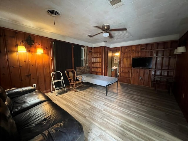 1638 Stafford St, Gretna, LA 70053 - rec room with wood finished floors, wood walls, a ceiling fan, and built in shelves